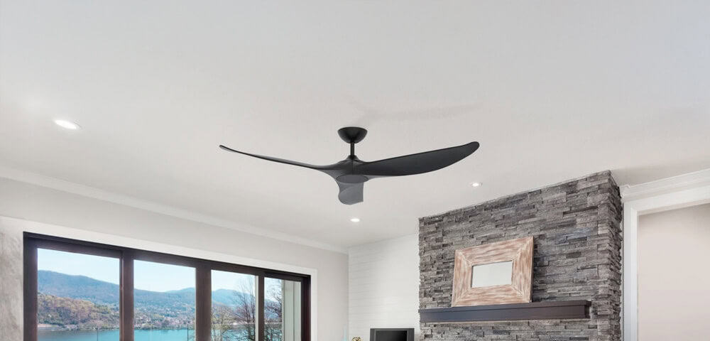 Modern living room interior with ceiling fan, stone accent wall, and large window overlooking a scenic outdoor landscape in Australia.