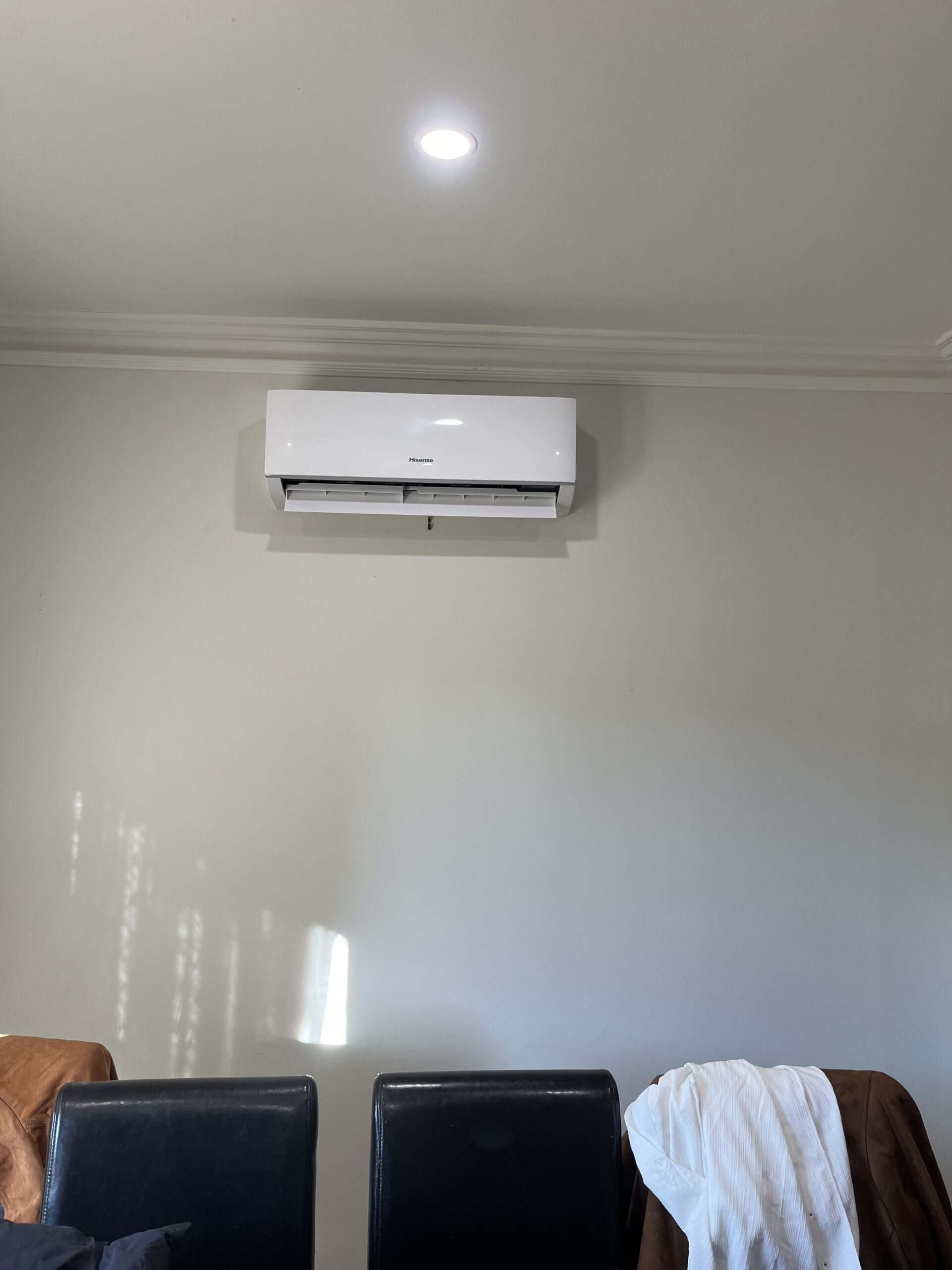 Air conditioning unit mounted on interior wall.